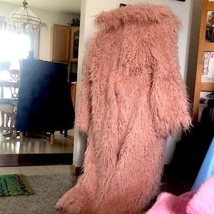 a pink fur coat with matching fur hat